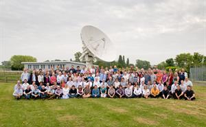 Group shot of some of the RAL Space Team with large satellite dish in the background
