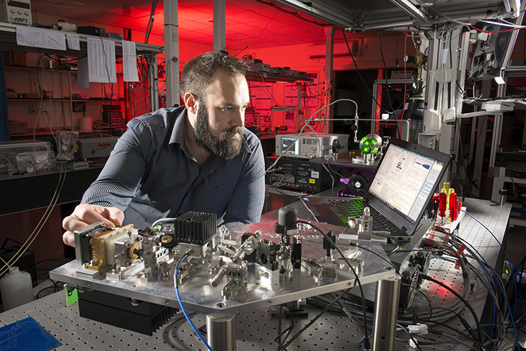 A researcher prepares an experiment in the laser spectroscopy lab.