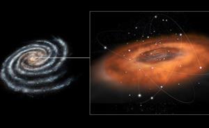 ​Artist's impression of the dense torus of gas and dust that orbits close within a few light years of the supermassive black hol