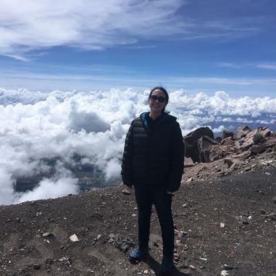 Eimear Gallagher is standing on the summit of Volcan Sierra Negra, at an altitude of 4600m! Eimear is above the clouds .