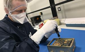 Camera electronic engineering model being finalised by a technician.