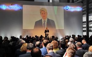Jo Johnson speaking in front of an audience at the inauguration of R100.