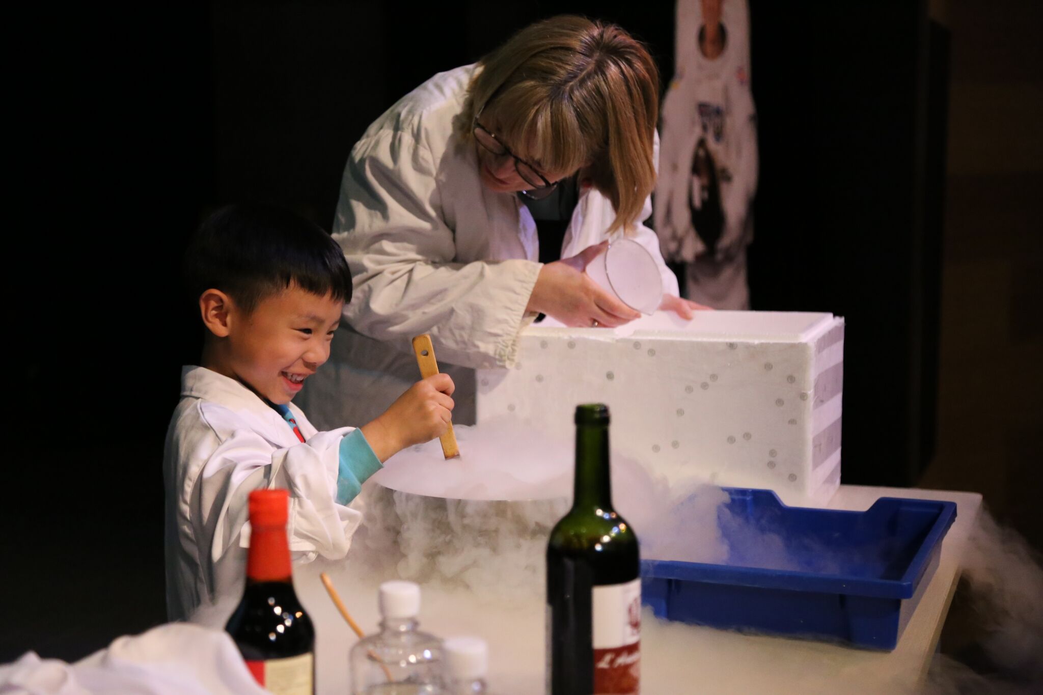 A child and a presenter doing a dry ice demonstration