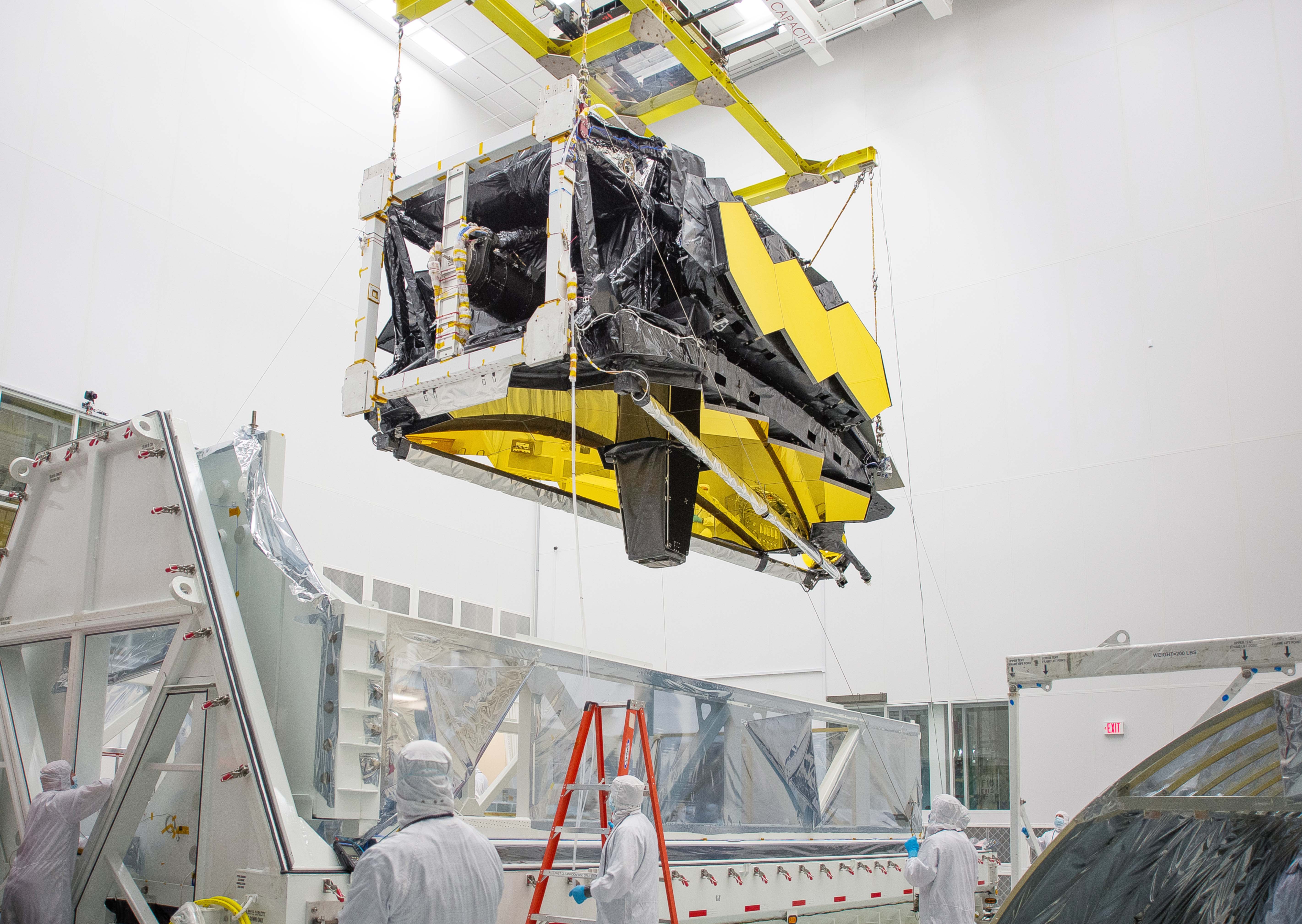 James Webb Space Telescope is lifted inside of a specially designed shipping container at NASA's Johnson Space Center.