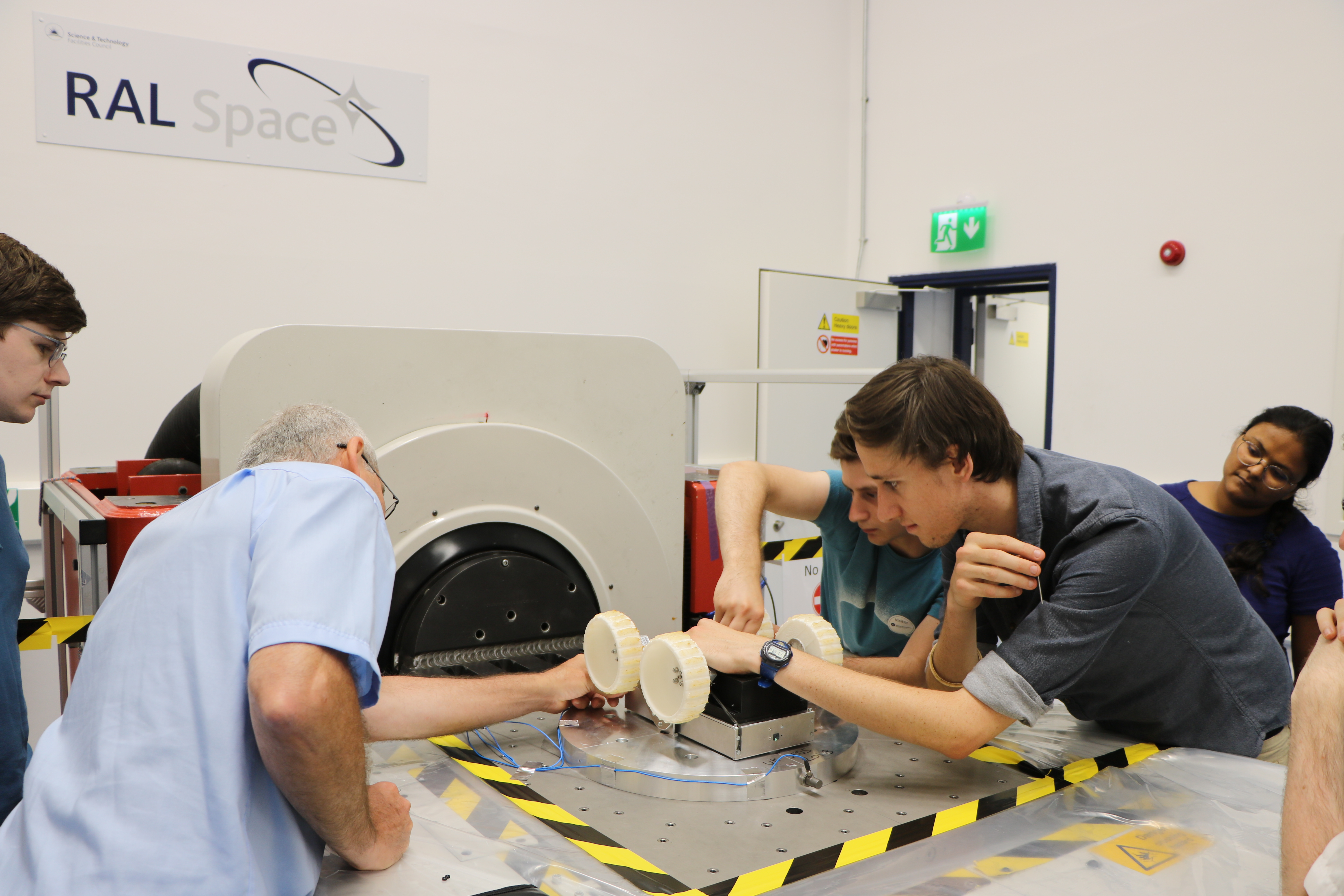 Students prepare their rover for testing on RAL Space's vibration table.